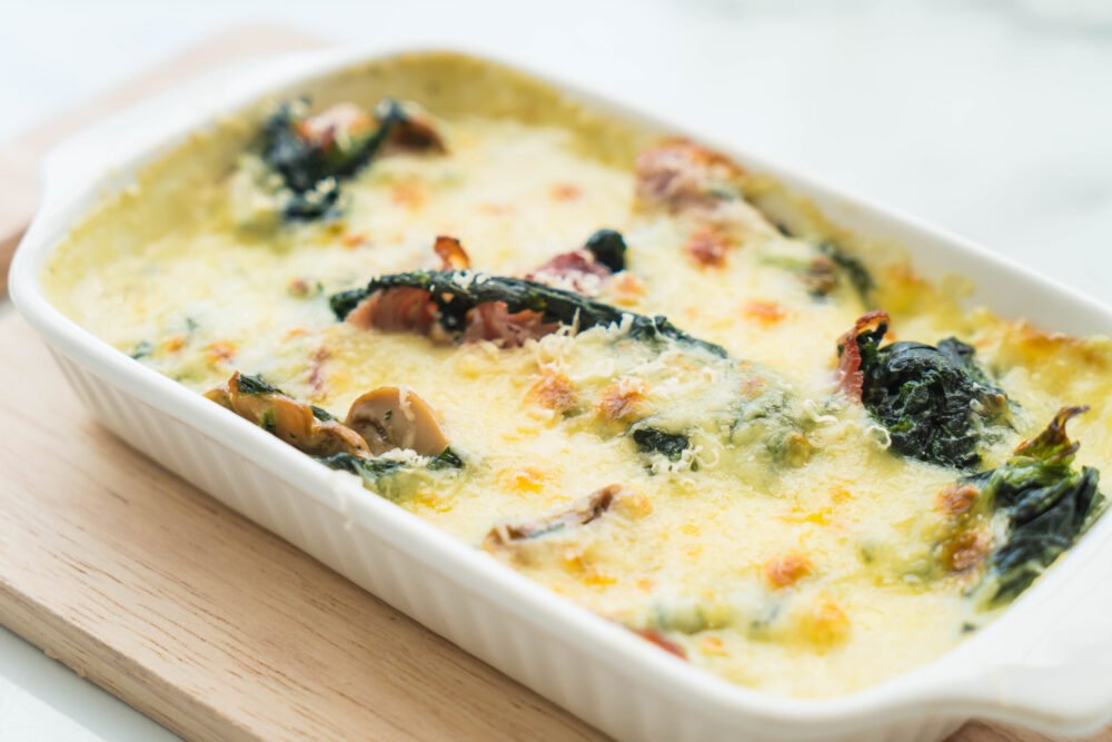 Casserole Dish with spinach lasagna in white plate - Italian food style