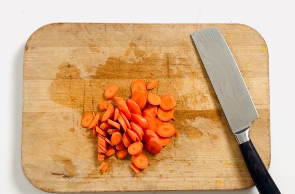 Smashed Cucumber Carrot Salad recipe chopped carrots on cutting board