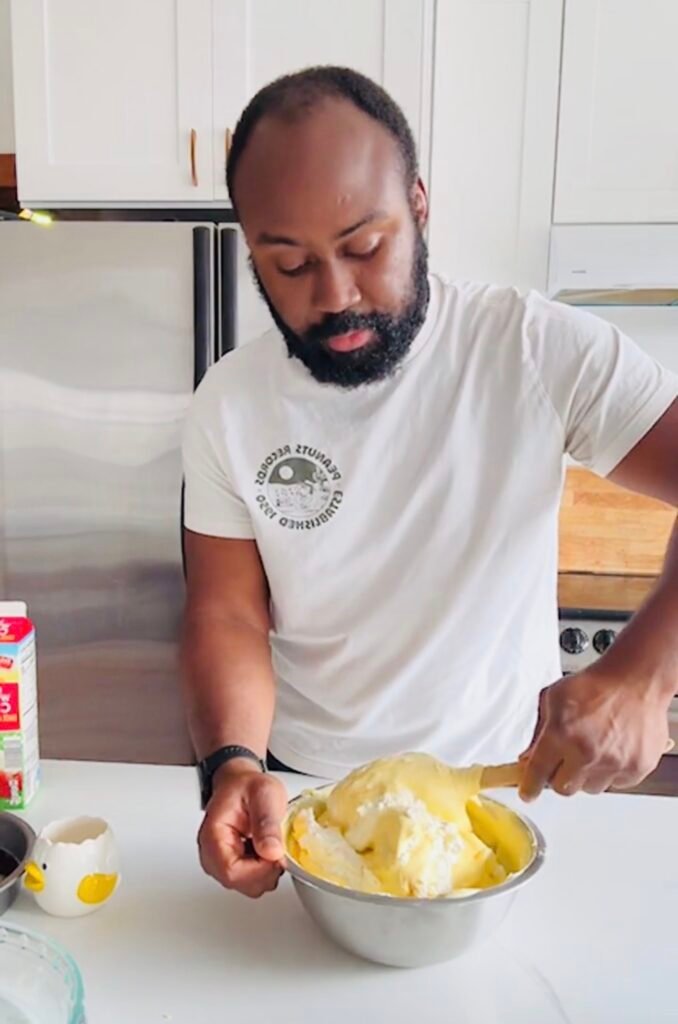 Classic tiramisu whipped cream being folded gently into mixture