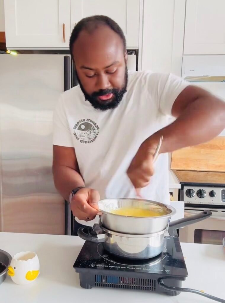 Classic tiramisu Sabayon being whisked over a double boiler until thick and pale