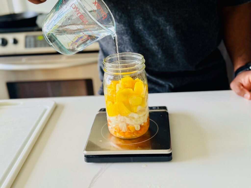 Fermented Habanero Hot Sauce - pouring salted water into jar