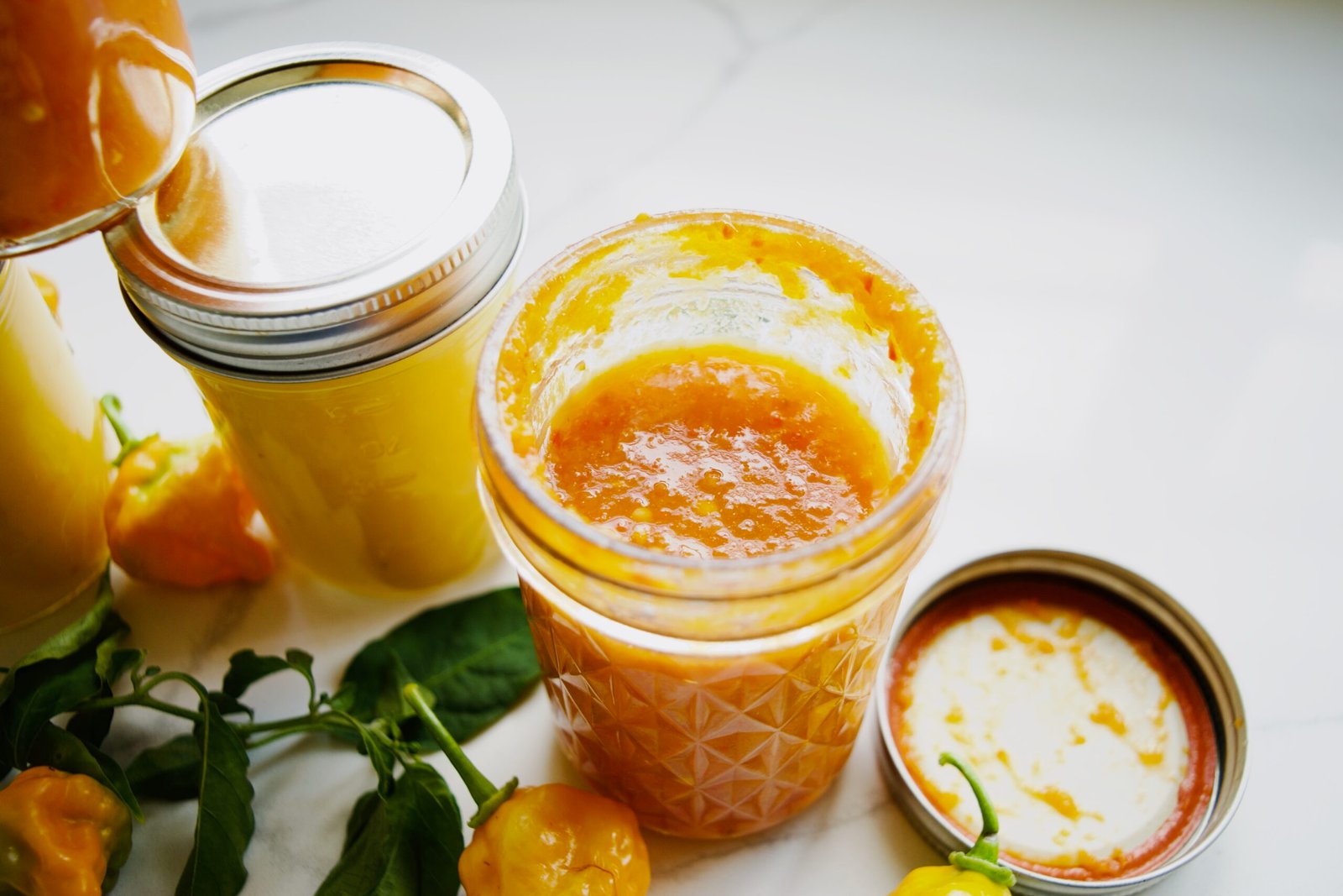 Fermented Habanero Hot Sauce Recipe with Classic and Mango Variations - jar of fermented habanero hot sauce with vibrant orange color