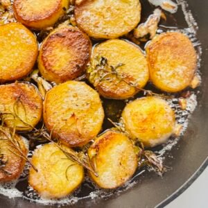 Thin Cut Melting Potatoes in a cast iron