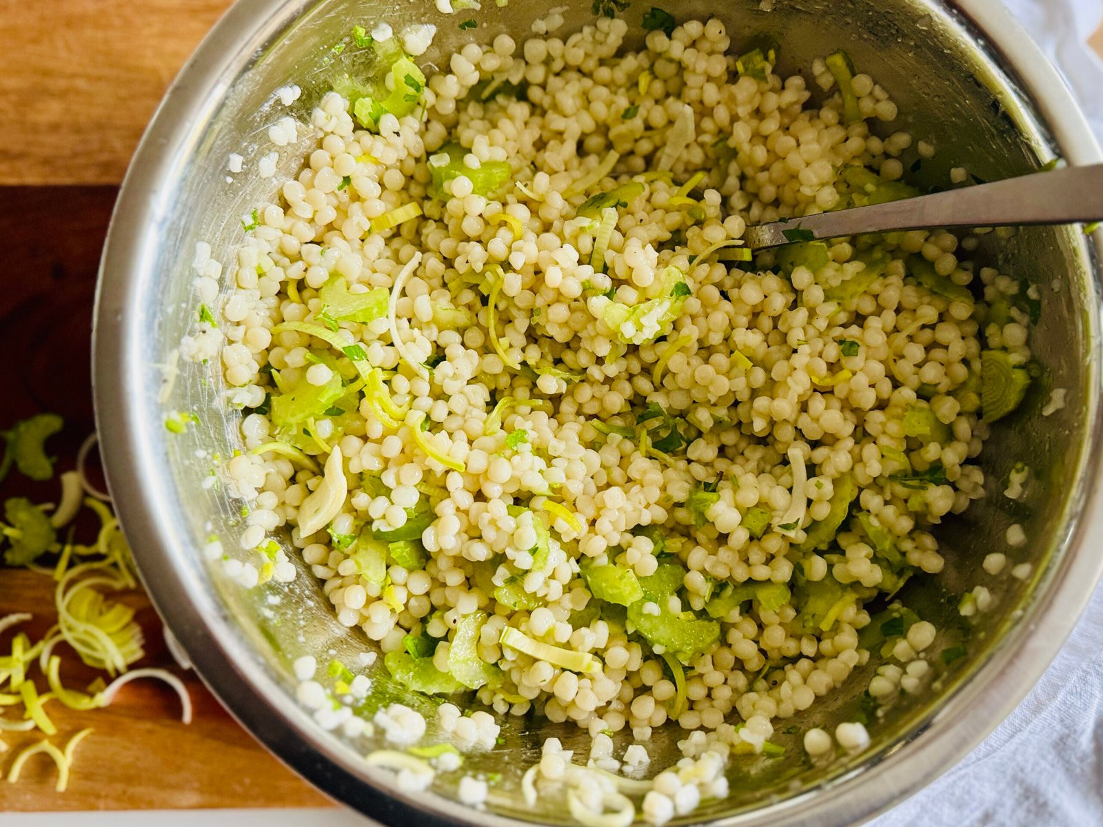 pearl couscous tossed it with olive oil, vinegar, lime juice, lime zest, mint, parsley, celery, and leeks