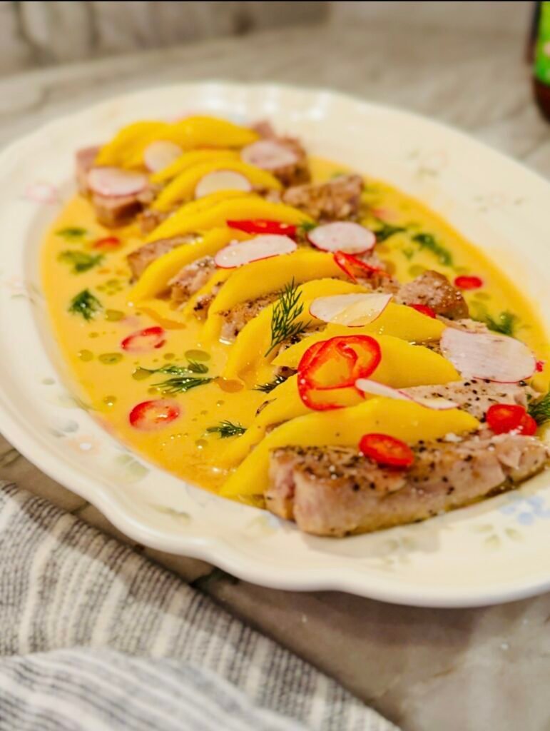 Ahi tuna platter with mango, red chilies, radish, and bright citrus sauce