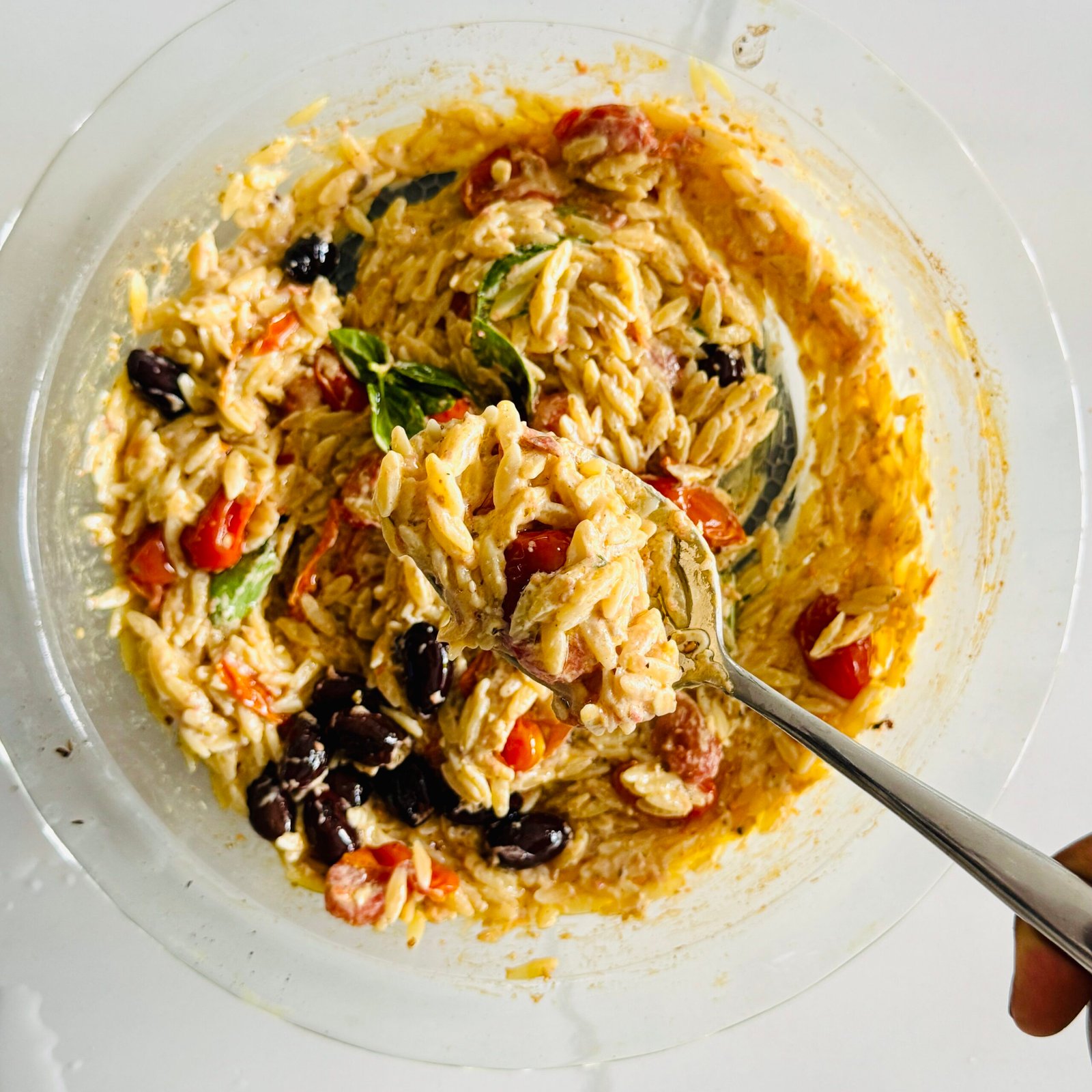 Roasted feta with cherry tomatoes, Kalamata olives, garlic, olive oil, and spices in a glass baking dish