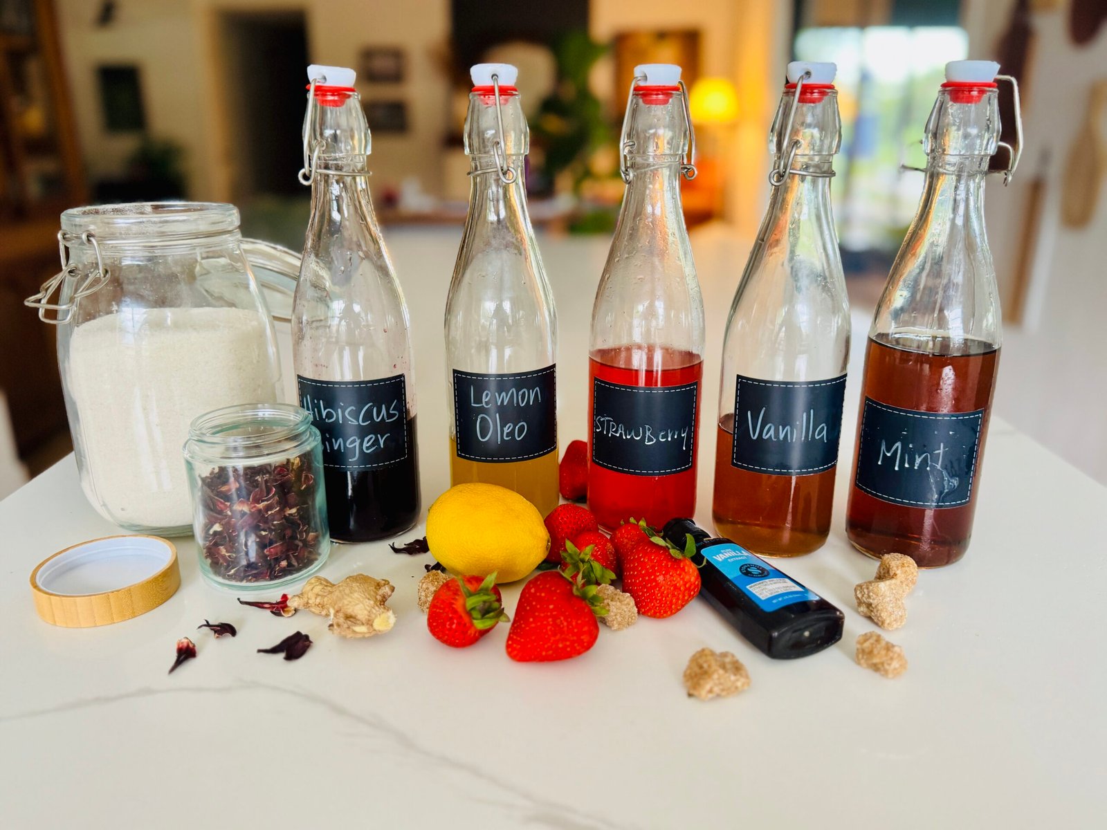 Homemade flavored syrups for drinks made with mint strawberries lemon vanilla hibiscus and ginger