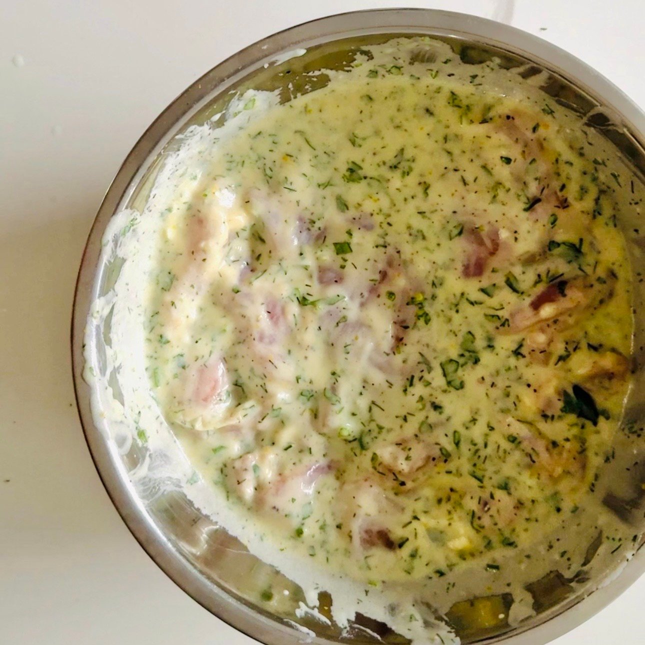 Chicken thighs coated in Greek yogurt lemon garlic marinade with oregano and spices