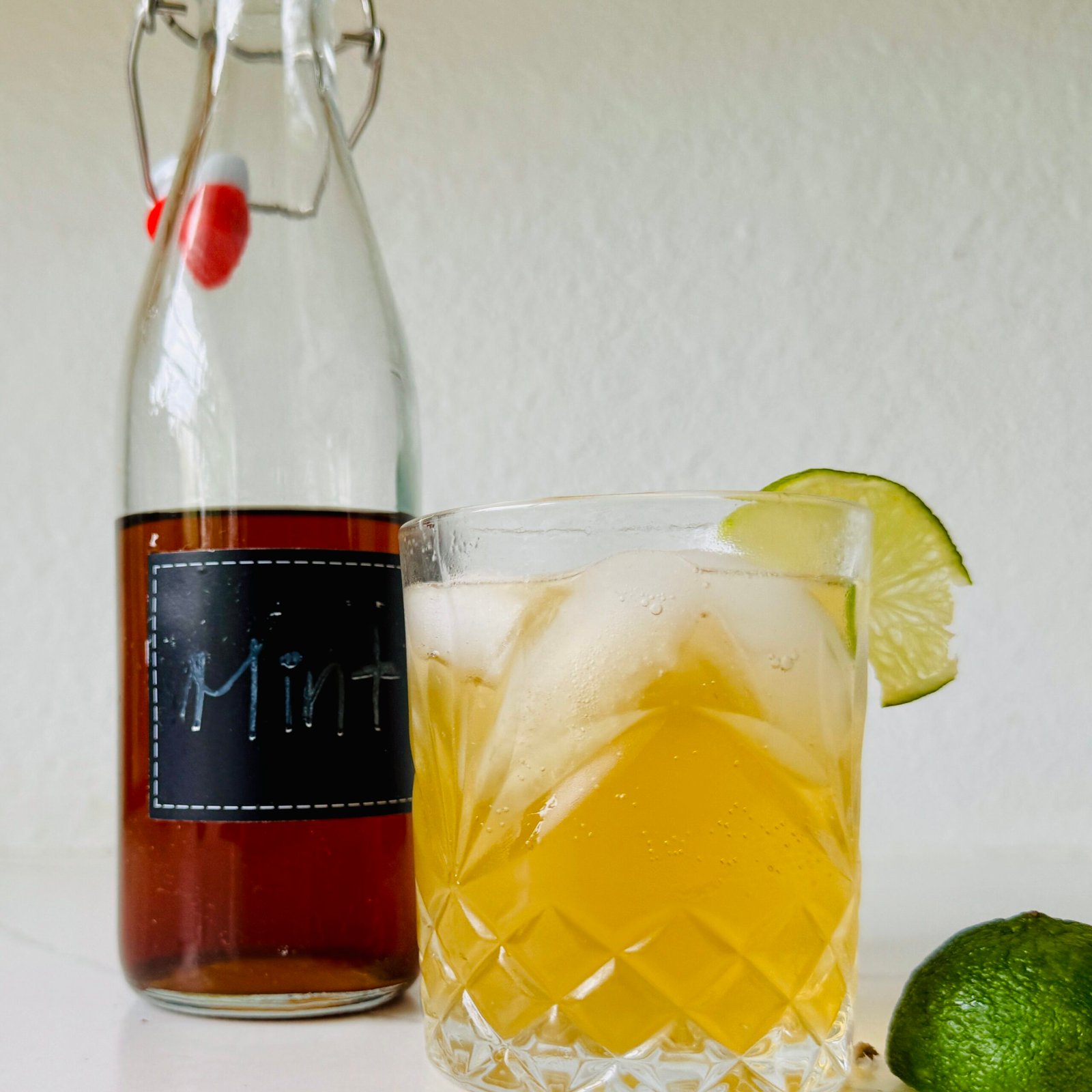 Fresh mint simple syrup beside a mojito