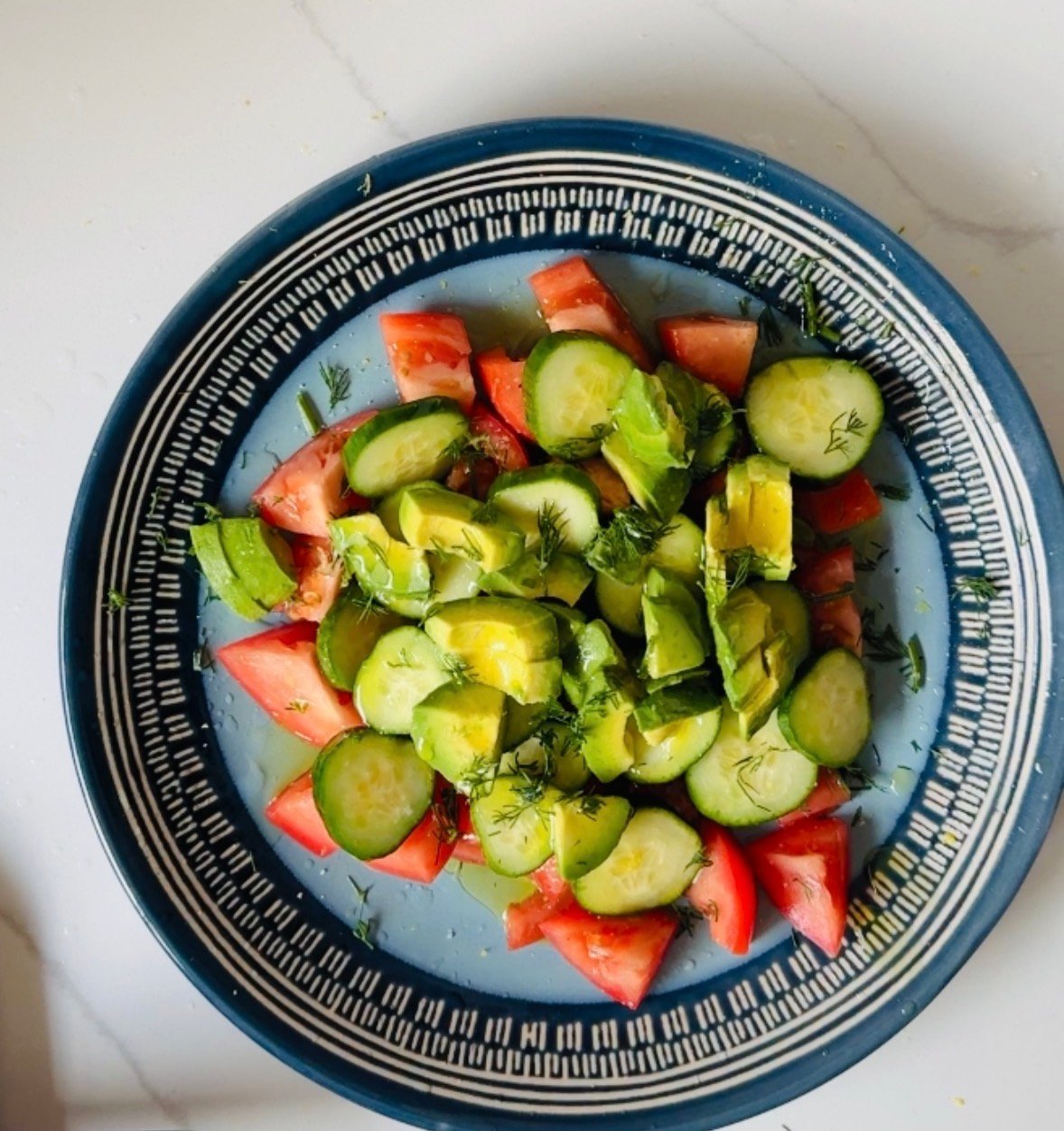 Avocado and cucumber layered over seasoned tomatoes with fresh dill.