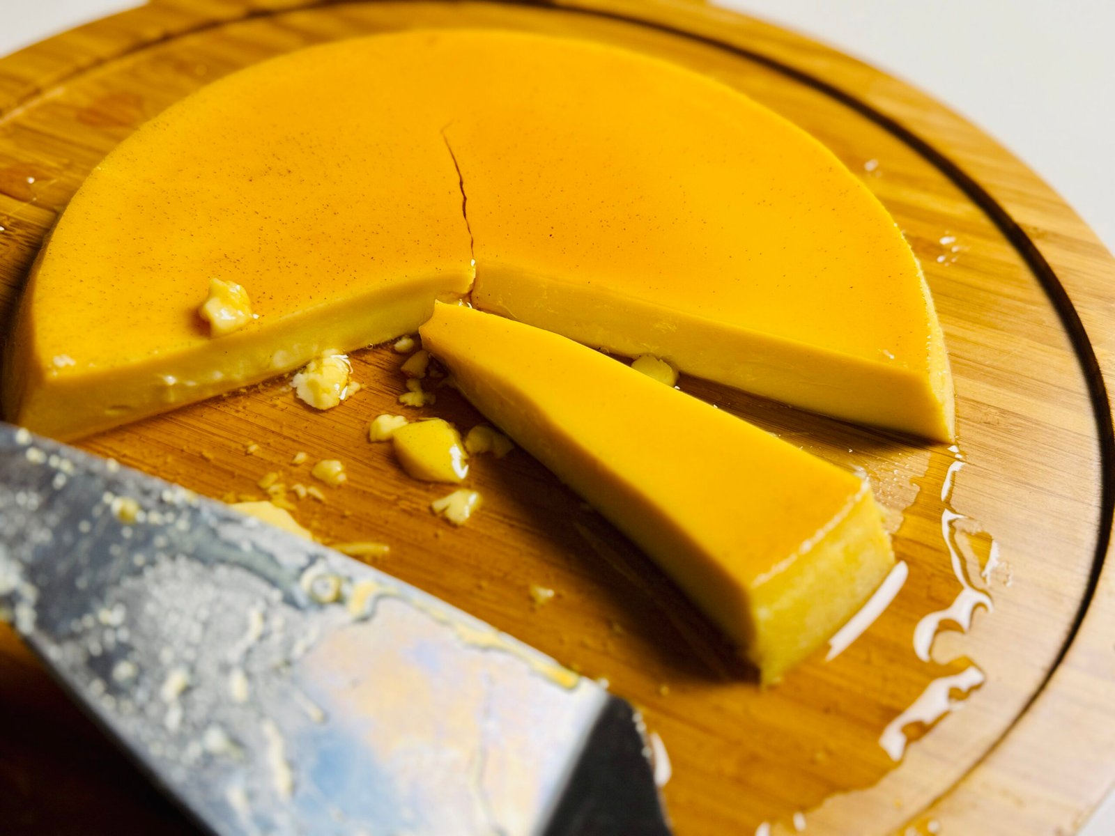 Side view of sliced extra creamy flan showing its smooth custard texture and caramel.
