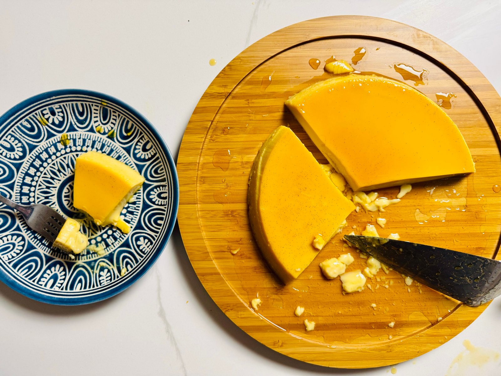 Extra creamy caramel flan with a plated slice ready to serve.
