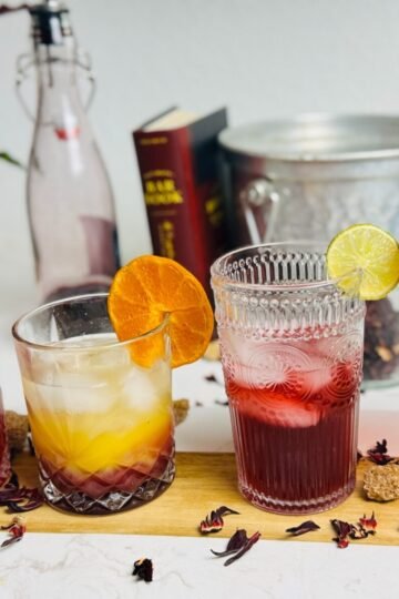 Four hibiscus-ginger drinks: a red Paloma, layered orange spritz, lime soda, and Champagne cocktail.