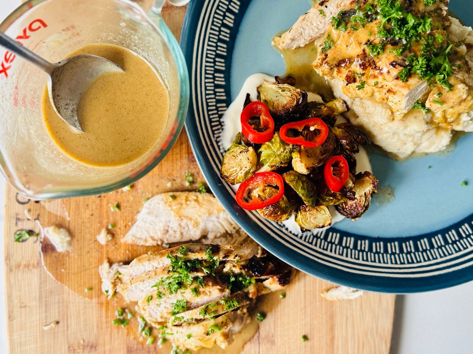 Lemon Dijon Chicken with Mashed Potatoes and Brussels Sprouts Lemon Dijon chicken served over mashed potatoes with roasted Brussels sprouts and extra pan sauce.