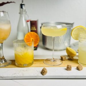 Lemon oleo-saccharum drinks: grapefruit spritz, rum punch, French 75, and lemonade.
