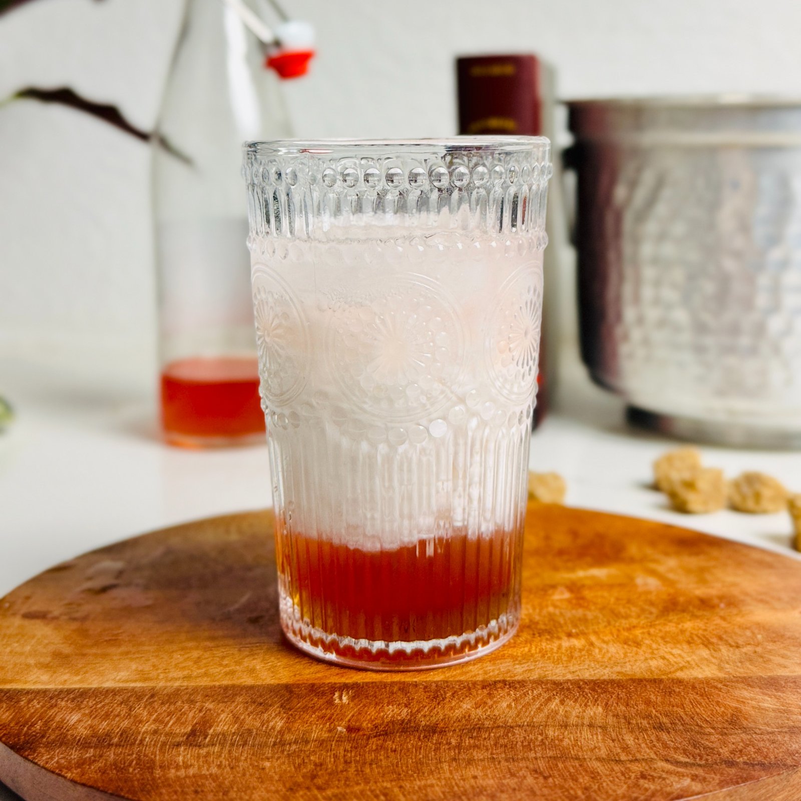 Strawberry Italian cream soda with white cream above a red strawberry syrup layer.