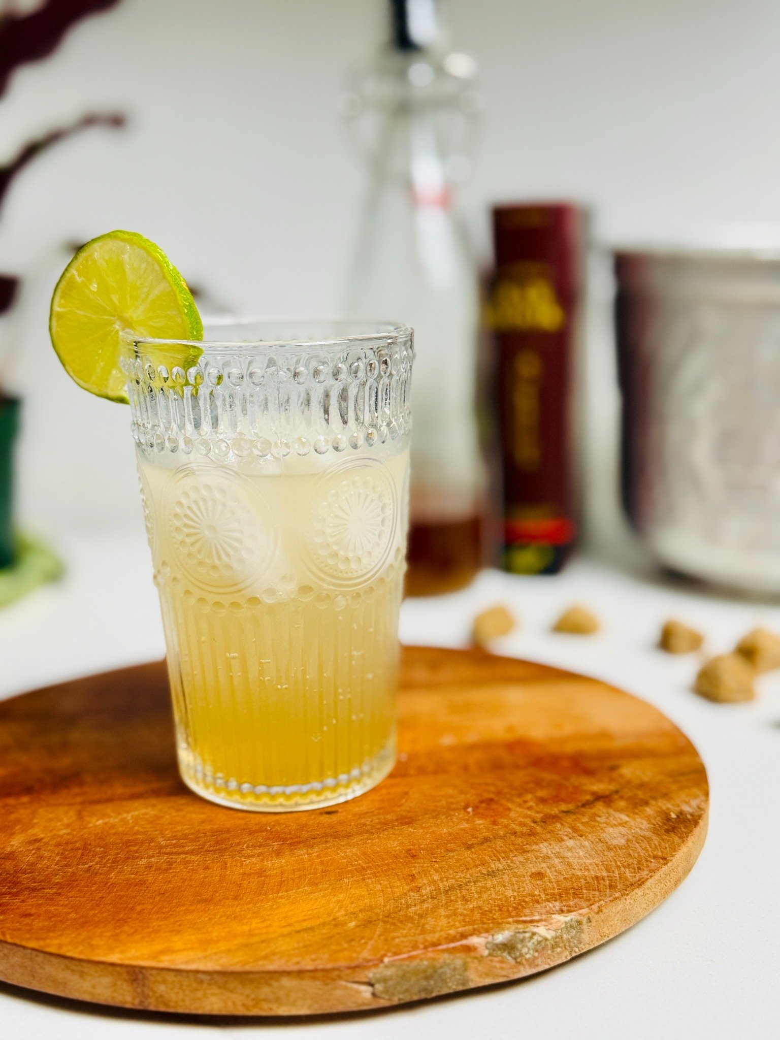 Vanilla ginger-lime soda over ice in a tall glass with a lime wheel.