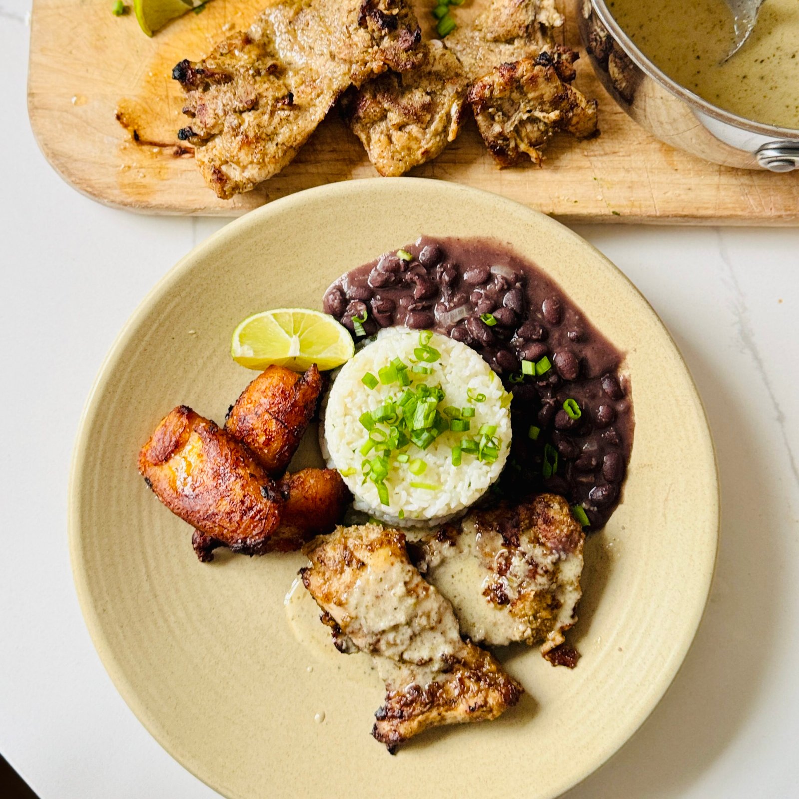 Finished jerk chicken bowl with coconut rice, black beans and golden fried plantains.