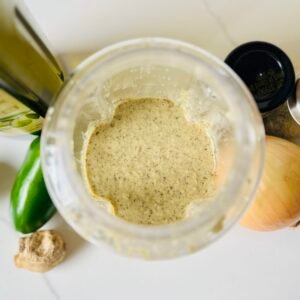 Blended jerk-inspired marinade prepared with onion, garlic, fresh ginger, green chilies, thyme, lime, and allspice.