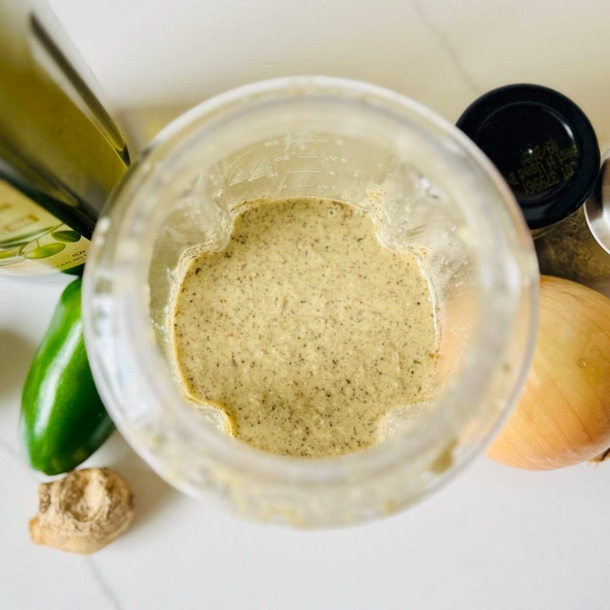 Homemade jerk marinade blended with fresh ginger, onion, garlic, chilies, thyme, lime and allspice.