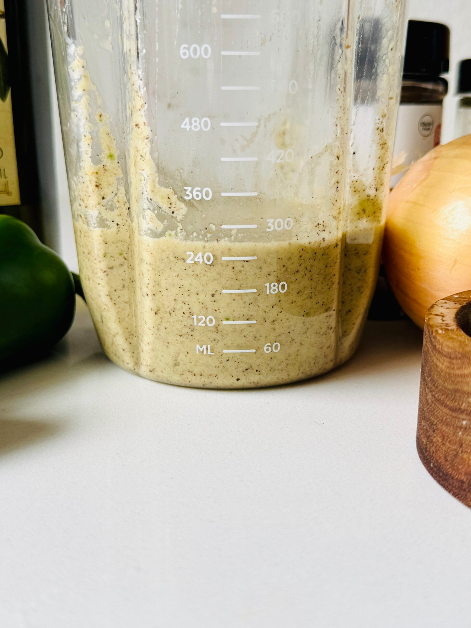 Prepared homemade jerk marinade with blended fresh aromatics and warm allspice.