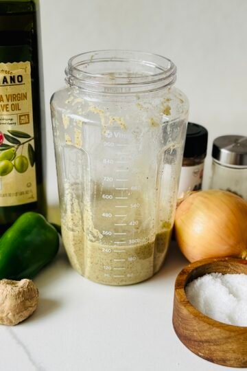 Finished homemade jerk-inspired marinade made with fresh ginger, garlic, chilies, lime, thyme, and allspice.